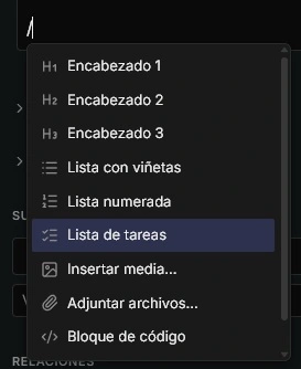 Menú de comandos del editor, abierto al escribir una barra
